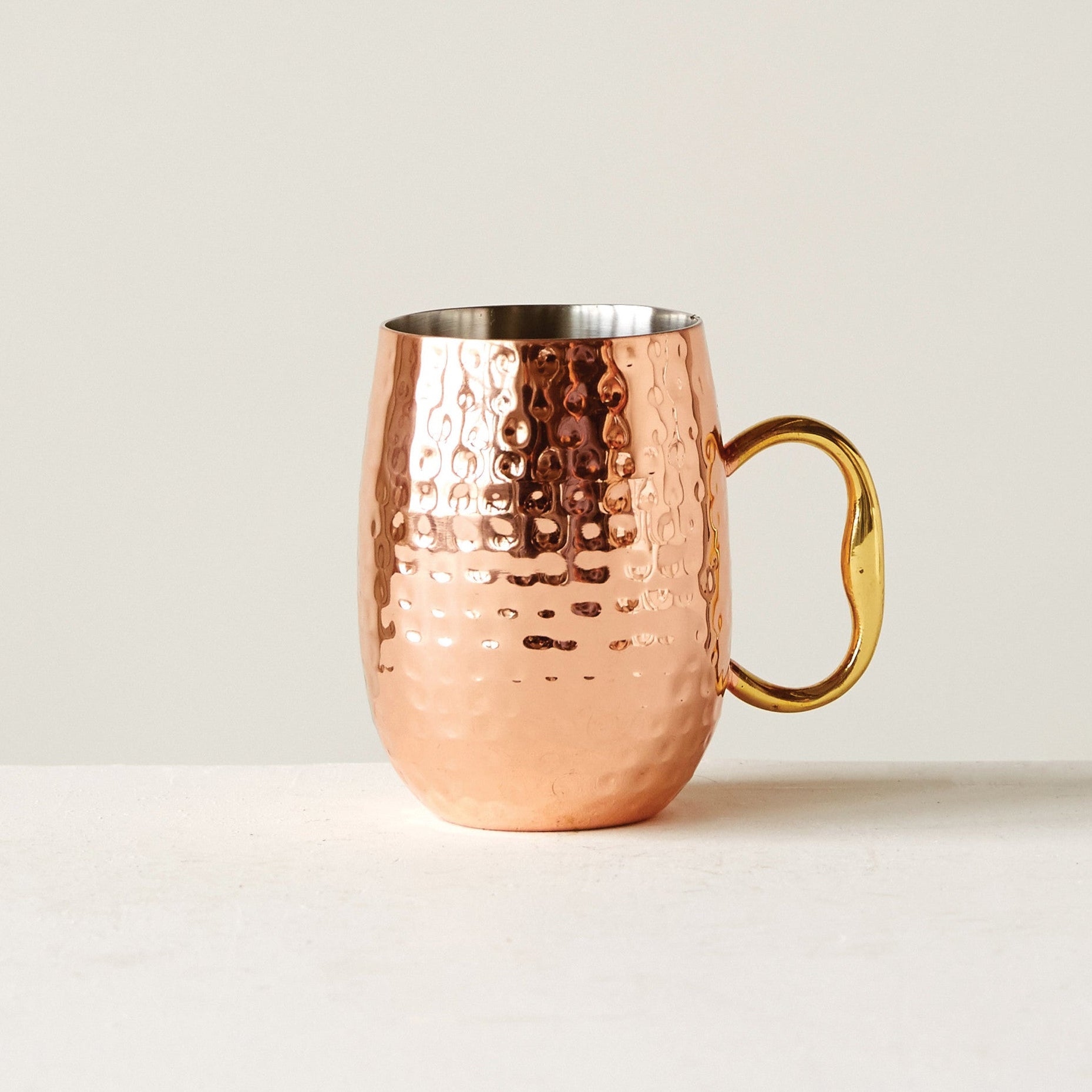 Copper mug with a textured surface on a white background