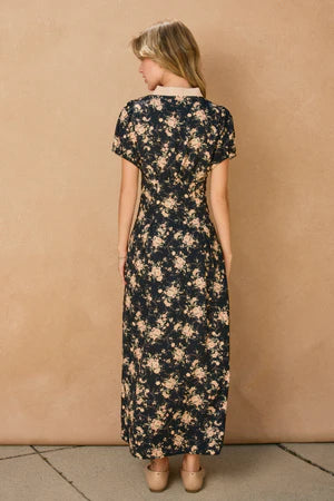 Woman wearing a floral dress against a beige wall