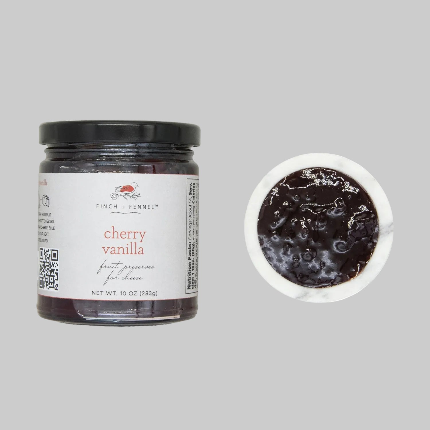 Jar of cherry vanilla preserve with a close-up of the preserve on a white background