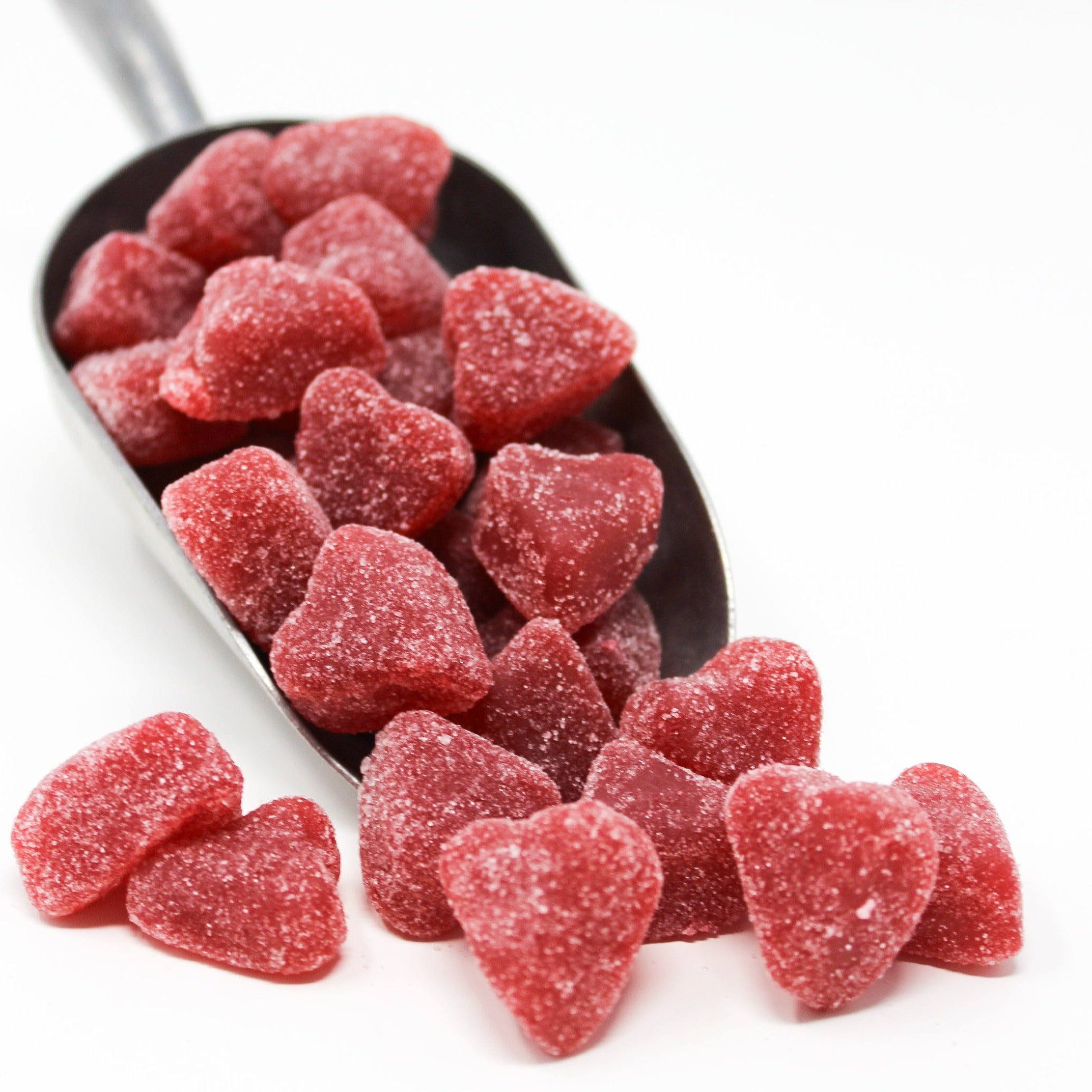 Sugared thick gummy heart candy in a scoop