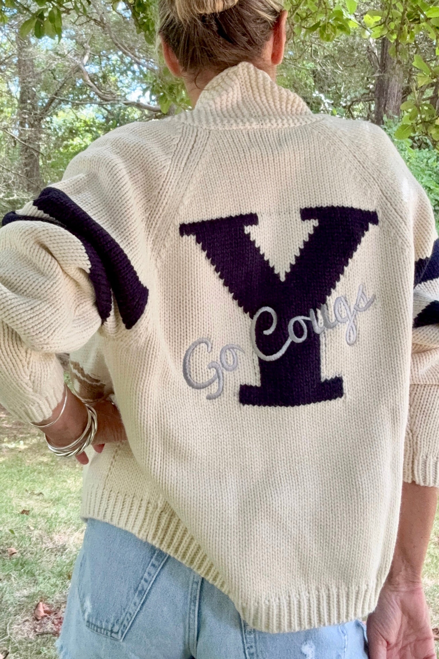 Woman wearing BYU vintage varsity cardigan. 