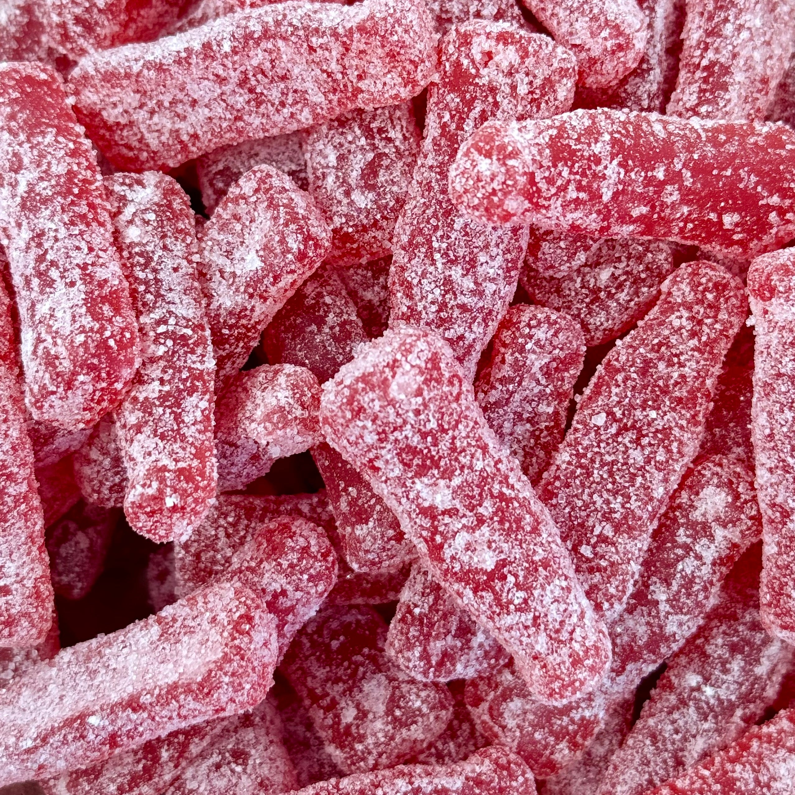 Sour raspberry bottles laying in a bowl