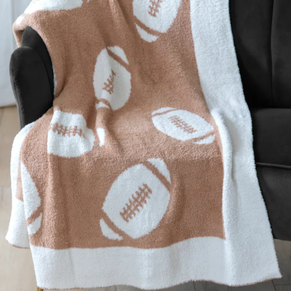 Blanket with football pattern draped over a chair