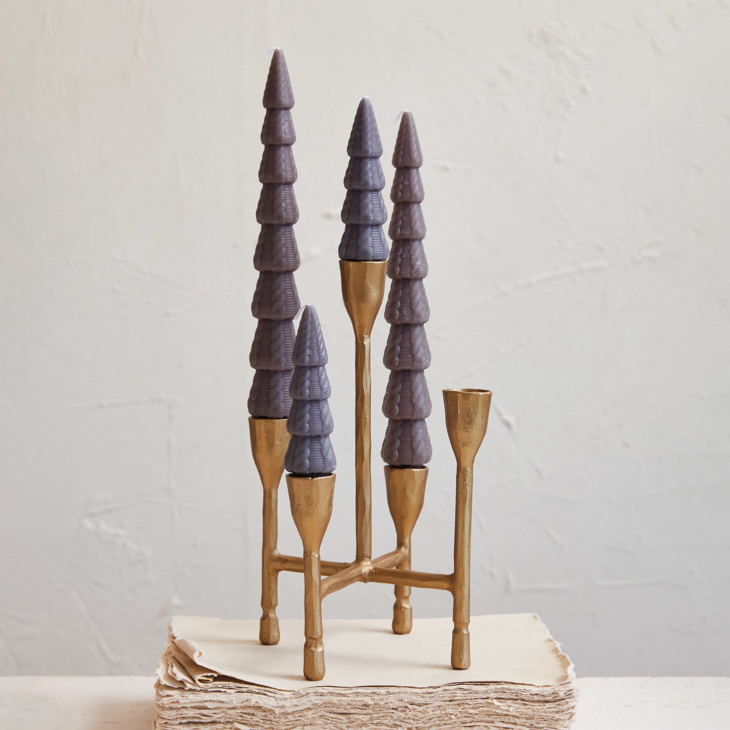 Decorative candle holder with purple and brown design on a light background