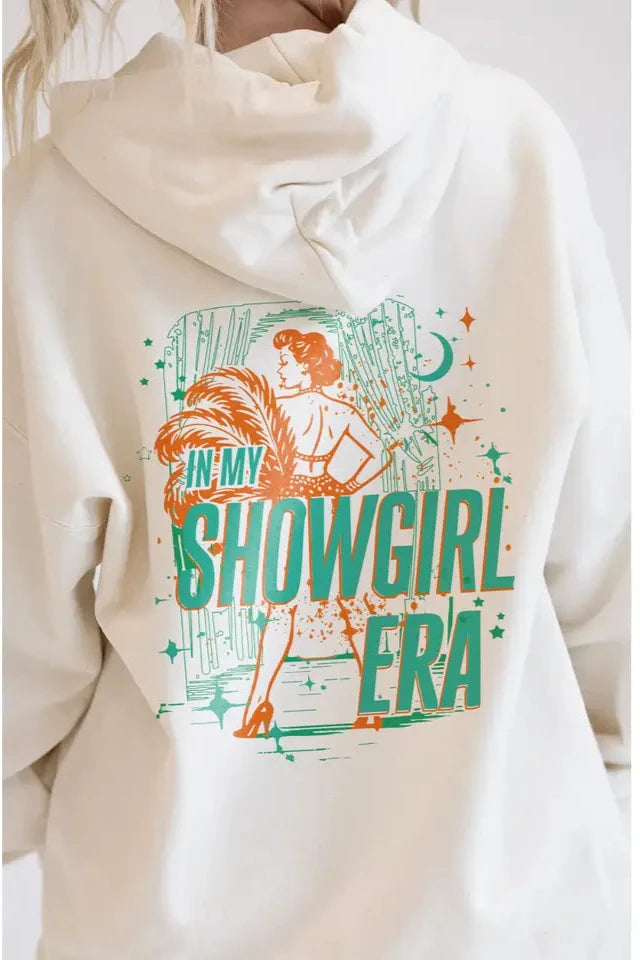White hoodie with 'In My Showgirl Era' graphic design on a plain background