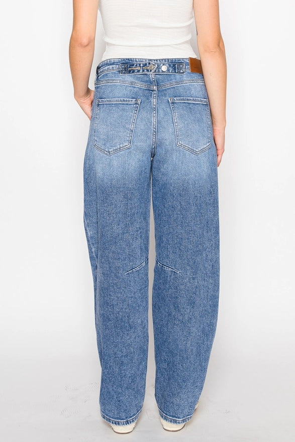 Blue jeans worn by a person on a white background