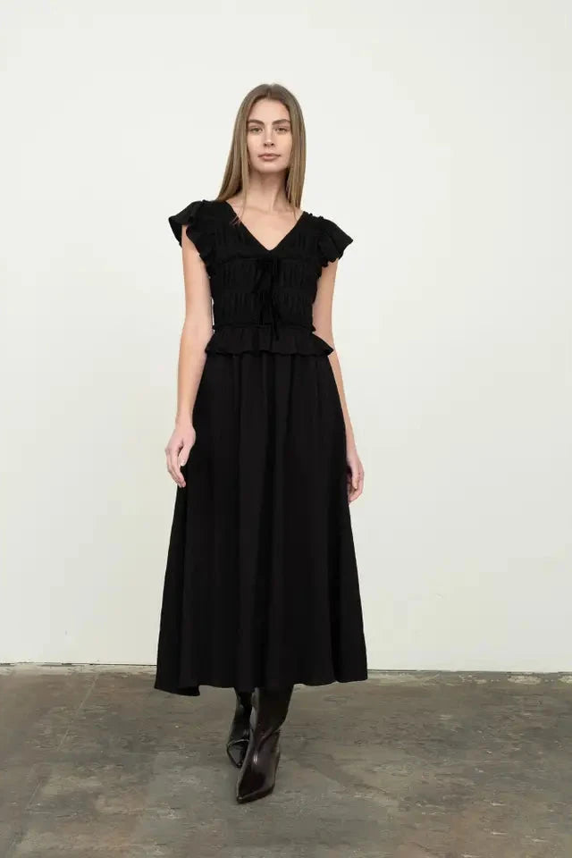 Woman wearing a black dress against a white background