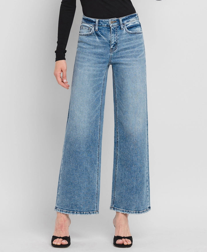 Light blue jeans worn by a person on a white background