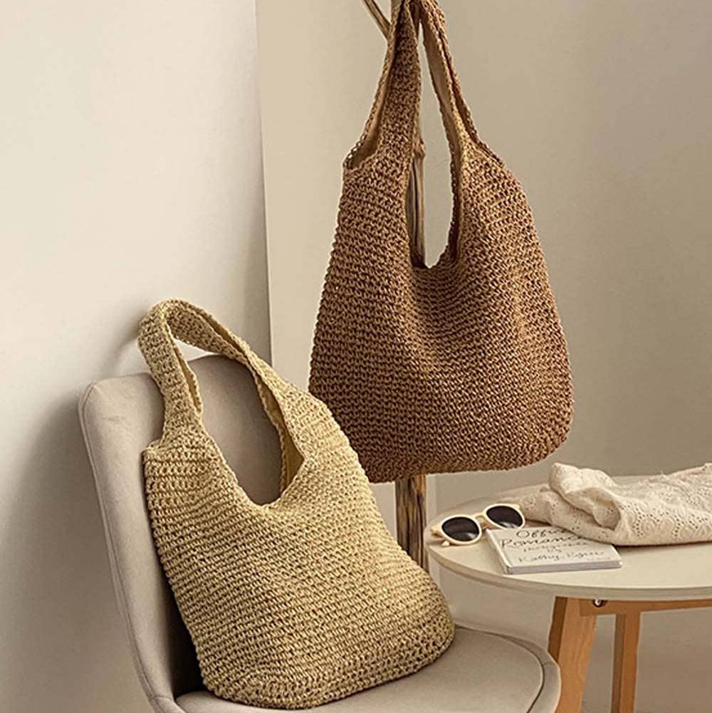 Two woven bags, one beige and one brown, on a chair and a hook against a neutral wall.