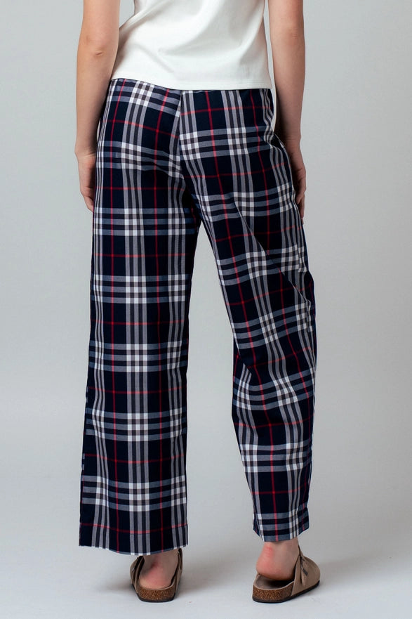 Person wearing plaid pants on a plain background