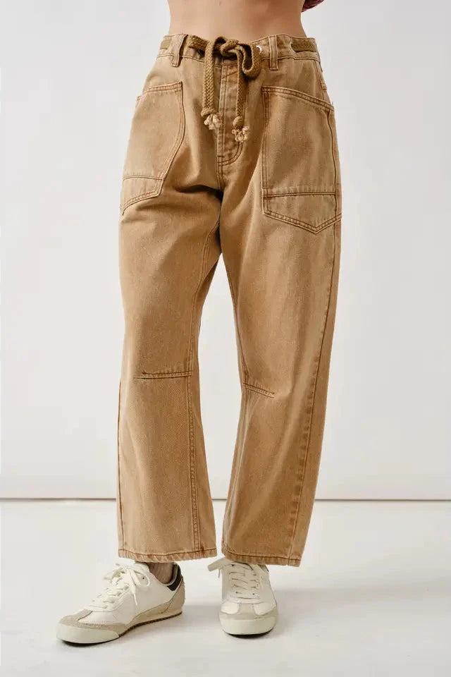 Tan pants worn by a person on a white background
