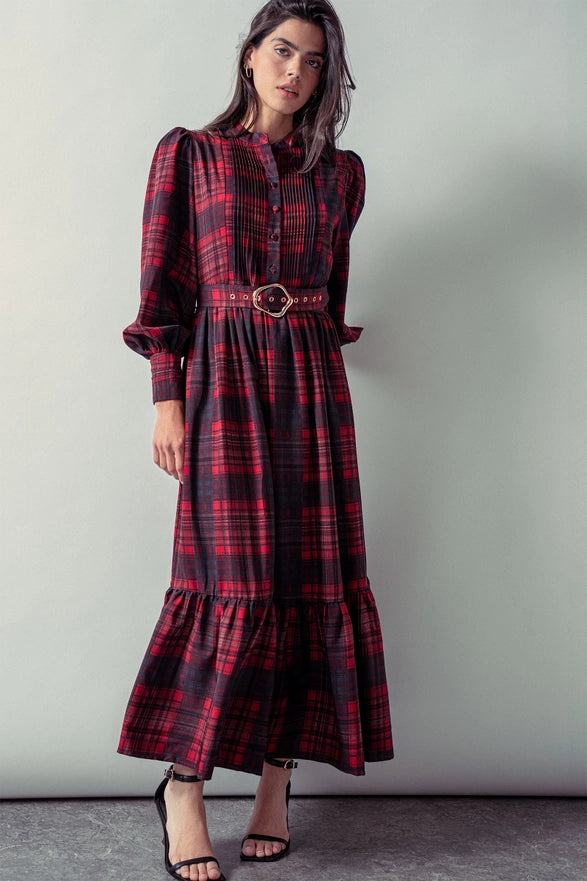 Woman wearing a red plaid maxi dress against a plain background.