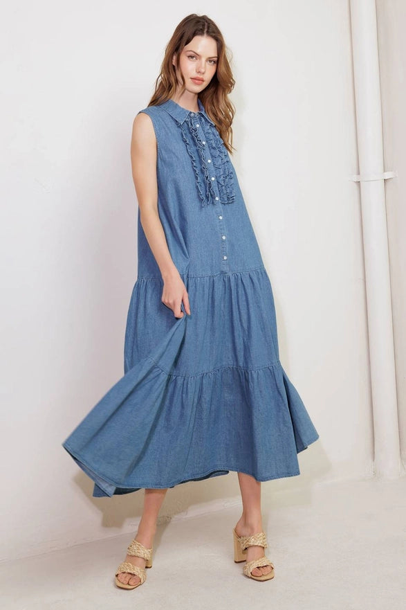 Woman wearing a blue dress with ruffled details against a white background