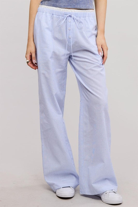 Light blue wide-leg pants worn by a person on a plain background