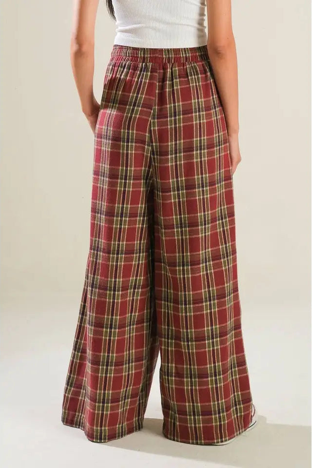 Plaid pants worn by a person on a plain background