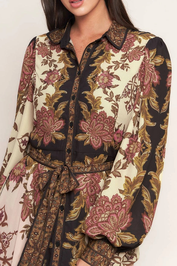 Floral patterned dresswith a belt on a plain background