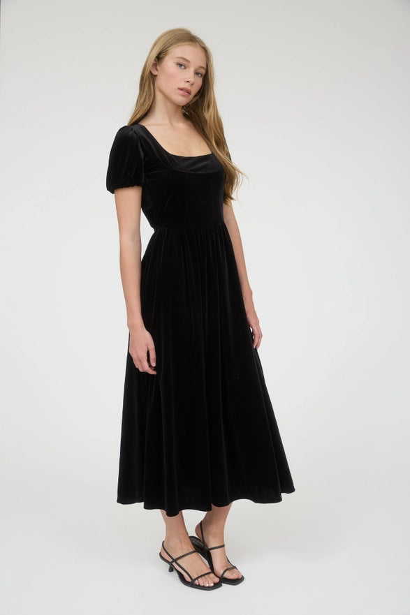 Woman wearing a black velvet dress on a white background