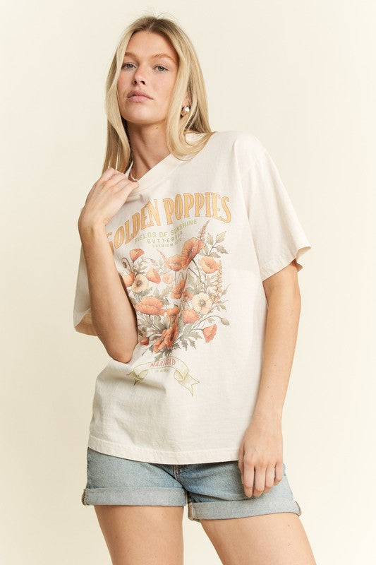 Woman wearing a white t-shirt with floral design and text on a beige background