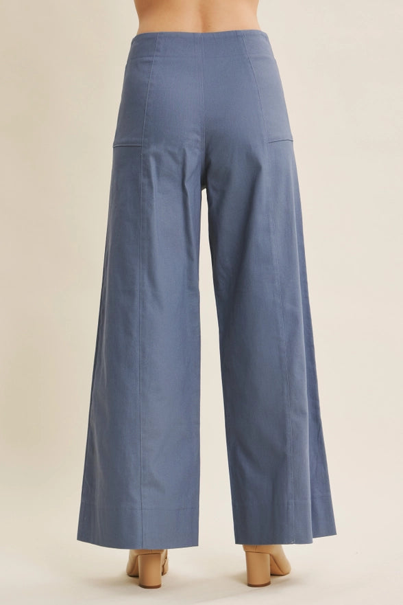 Blue wide-leg pants on a beige background