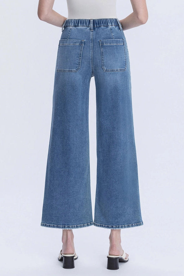 Wide-leg jeans worn by a person on a white background