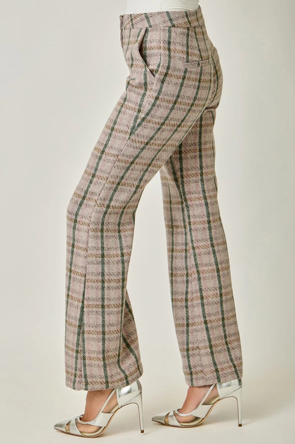 Plaid pants worn by a person on a plain background