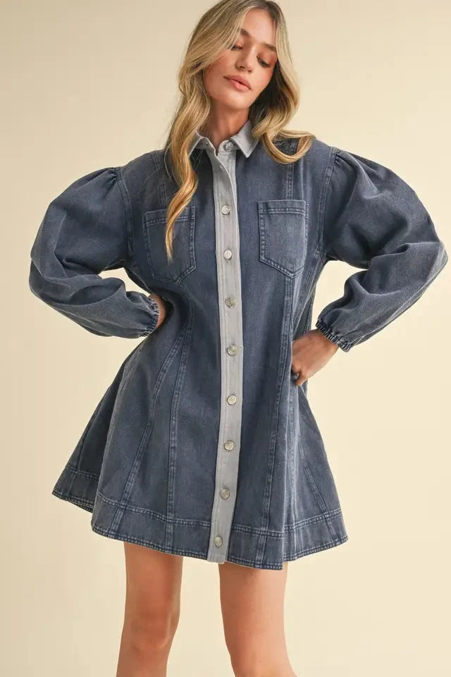 Woman wearing a denim dress with a plain background