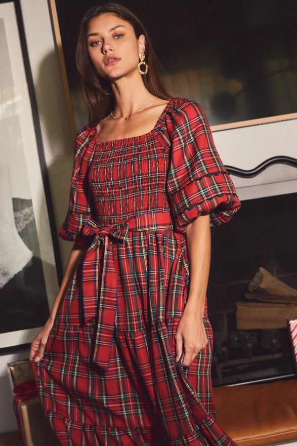 Woman wearing a red plaid midi dress with puff sleeves