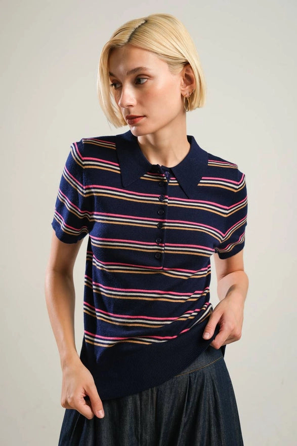 Woman wearing a striped polo shirt with a plain background