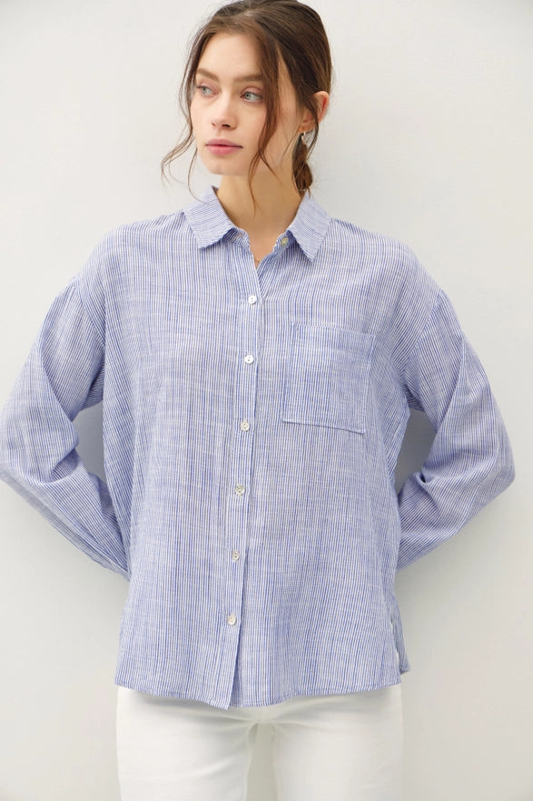 Woman wearing a blue checkered shirt against a white background