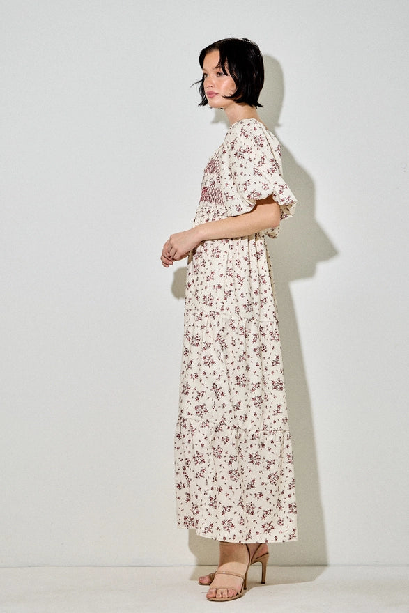 Woman wearing a floral dress against a white background