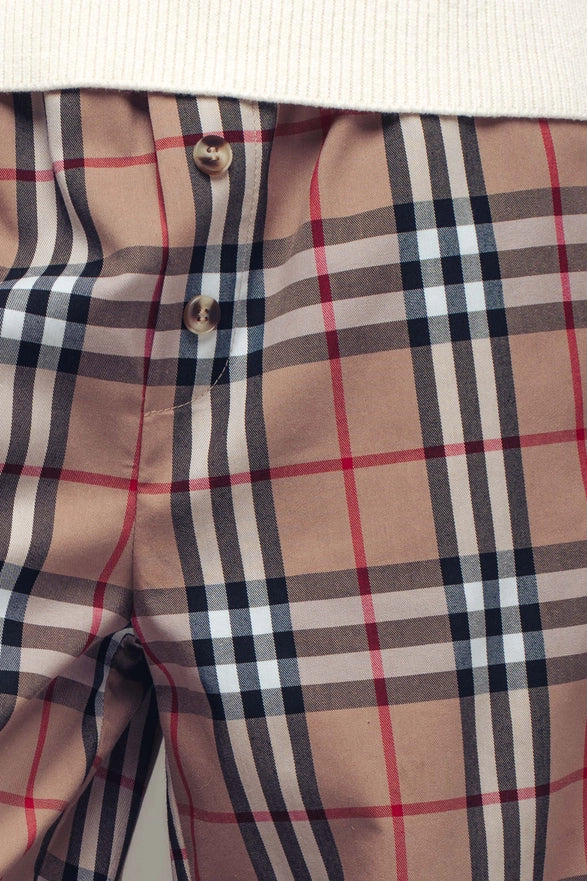 Close-up of plaid pants with a prominent check pattern.