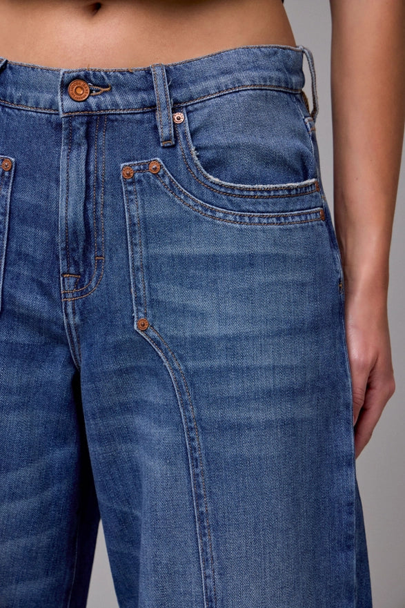 Close-up of blue jeans with a neutral background