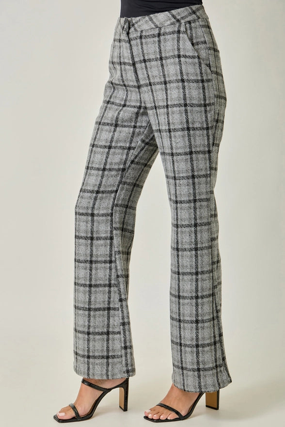 Plaid pants worn by a person on a plain background