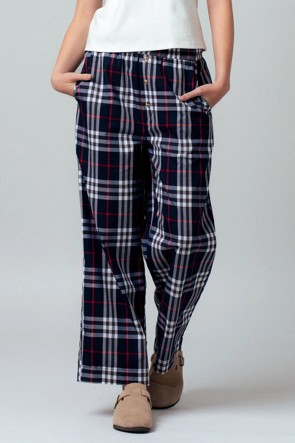 Person wearing plaid pants on a plain background