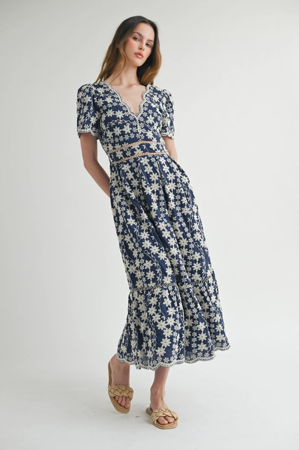 Woman wearing a blue floral dress on a white background