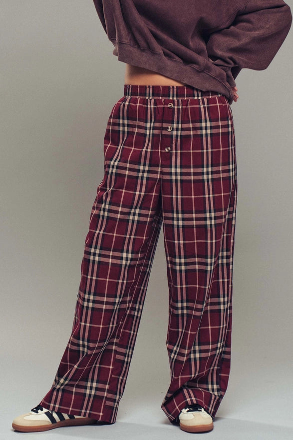 Plaid pants worn by a person on a plain background