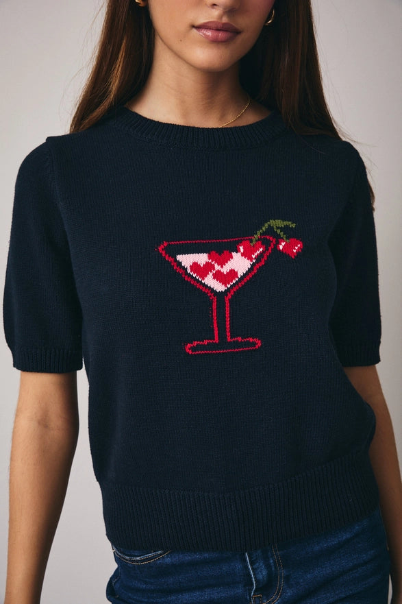 Navy blue sweater with a cocktail design worn by a person