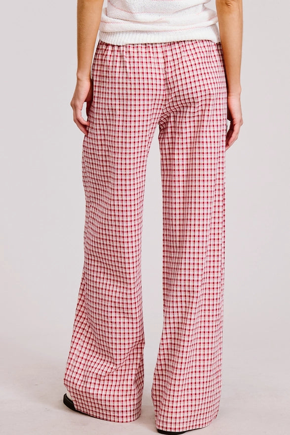 Red and white checkered pants worn by a person on a plain background