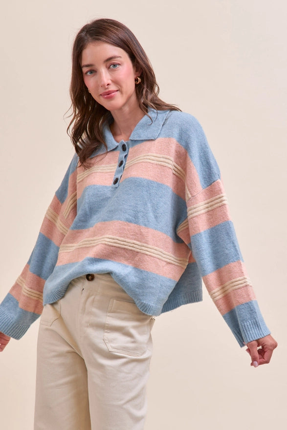 Woman wearing a striped sweater with a beige background