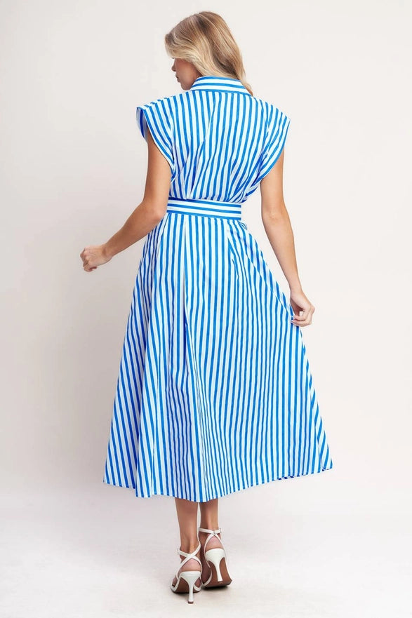 Woman wearing a blue and white striped dress on a plain background