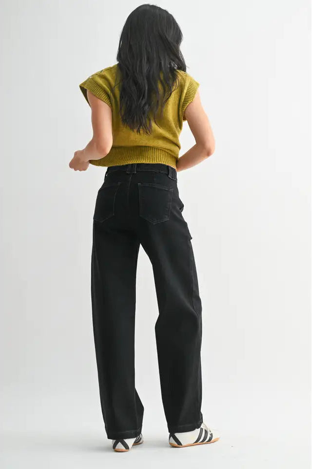 Person wearing a mustard yellow top and black pants on a white background
