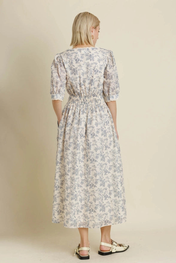 Woman wearing a floral dress against a beige background