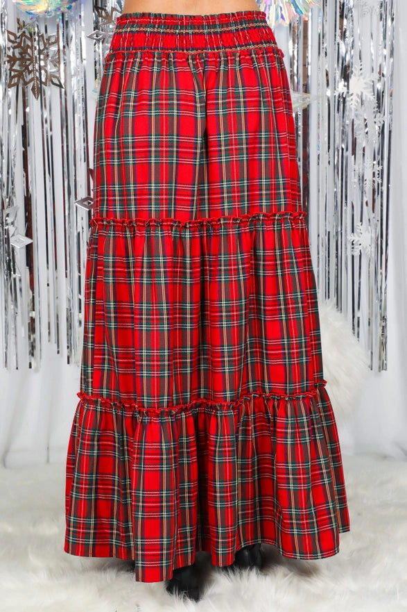 Red plaid skirt with ruffled layers on a white background