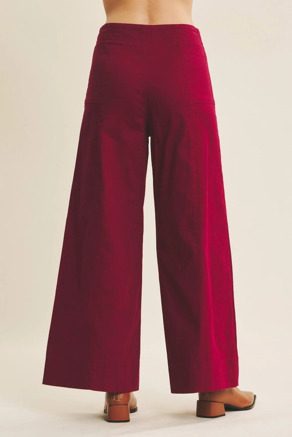 Maroon wide-leg pants on a neutral background
