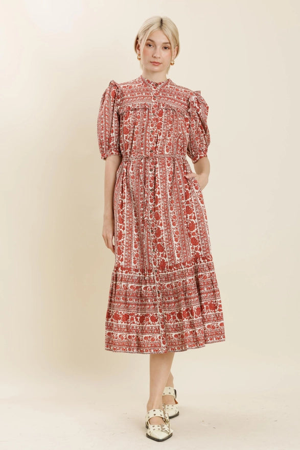 Woman wearing a red floral dress on a beige background