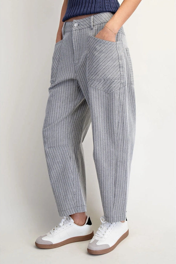 Person wearing blue and white striped pants with a plain background