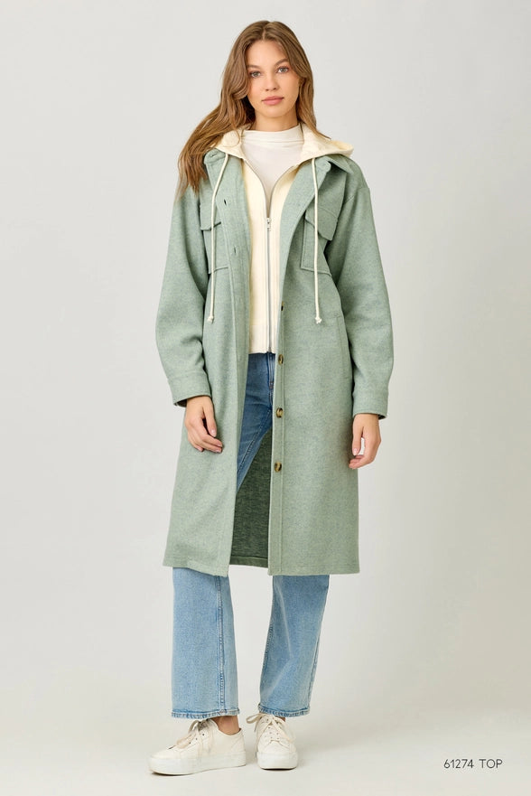 Woman wearing a green coat with a white background