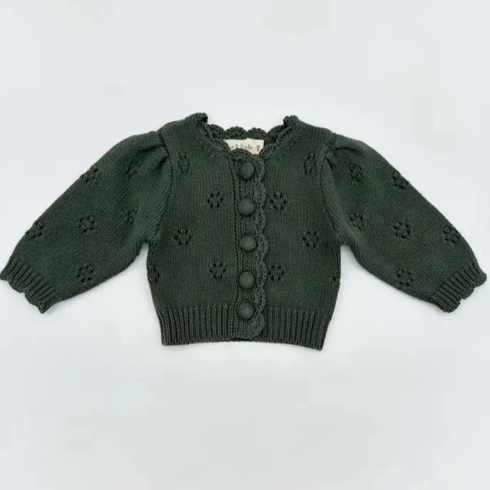 Green knitted cardigan with button details on a white background