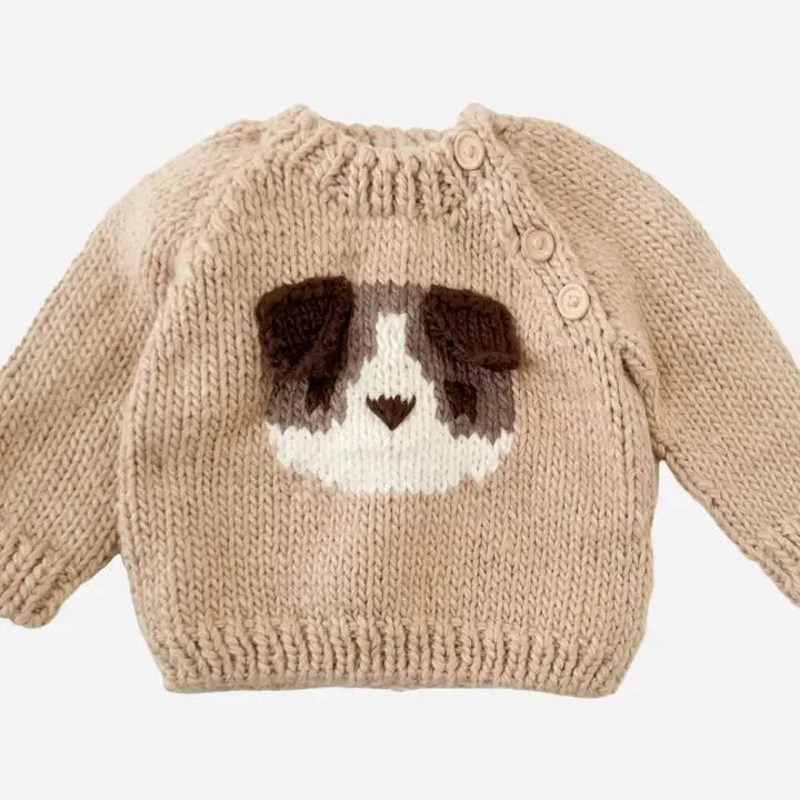 Knitted sweater with a dog face design on a white background