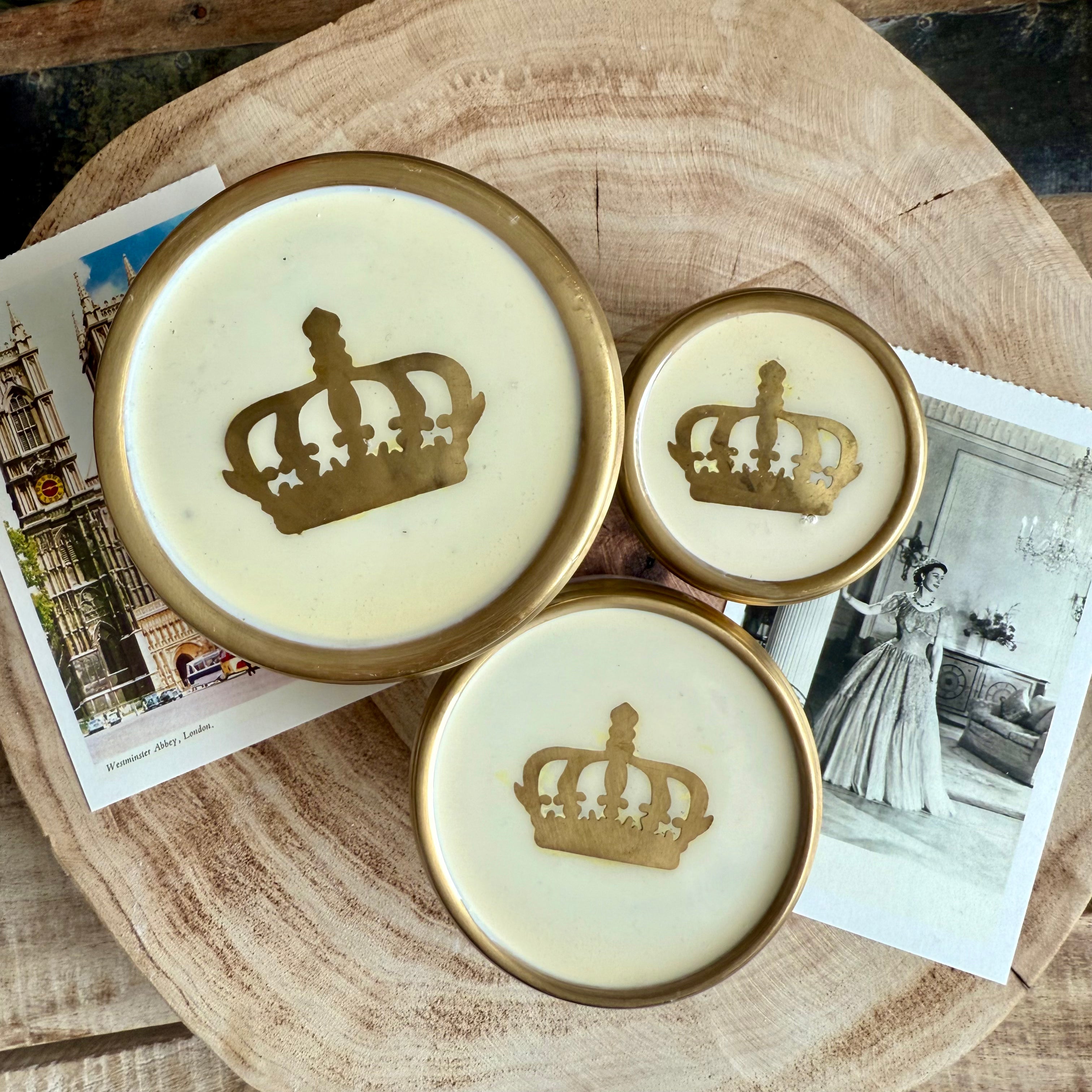 Product shoot of gold and glass crown jar.